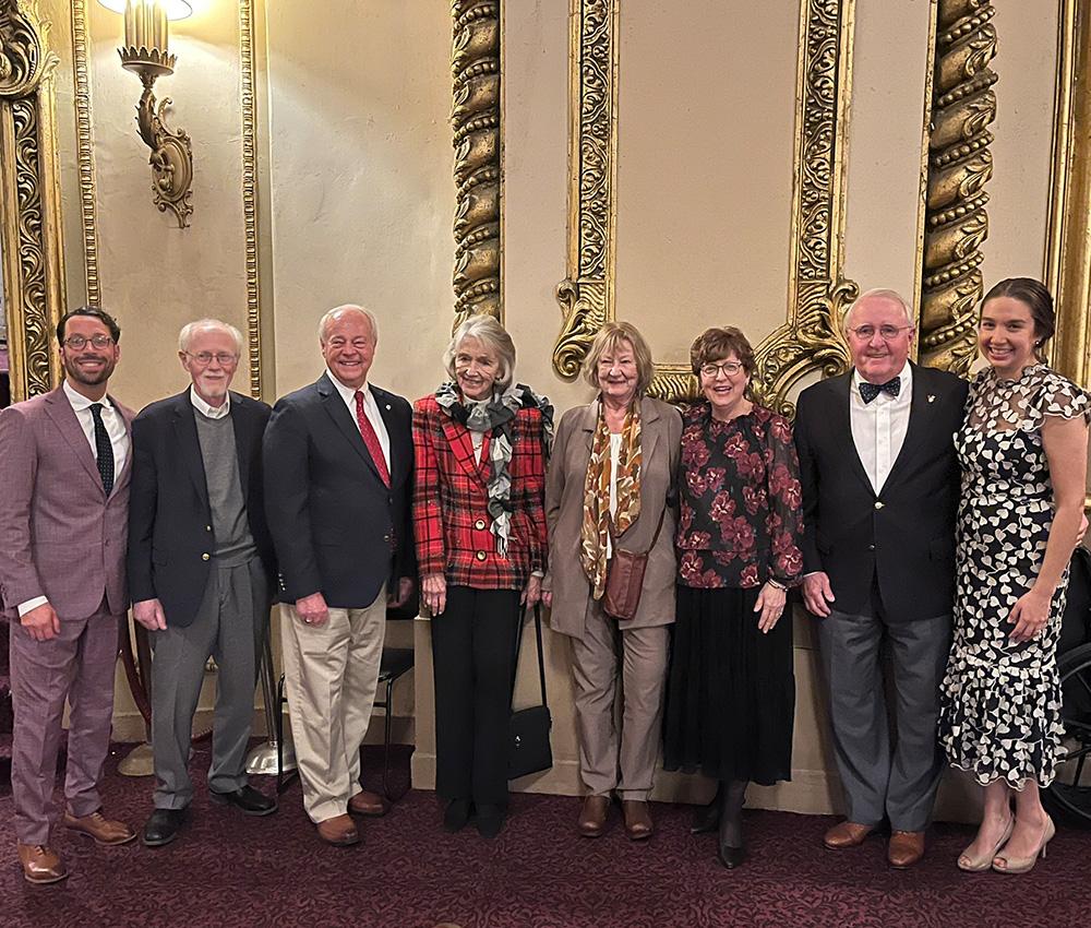 A group of 8 Ronald McDonald House Albany leaders past and present pose for a photo at the Palace Theatre